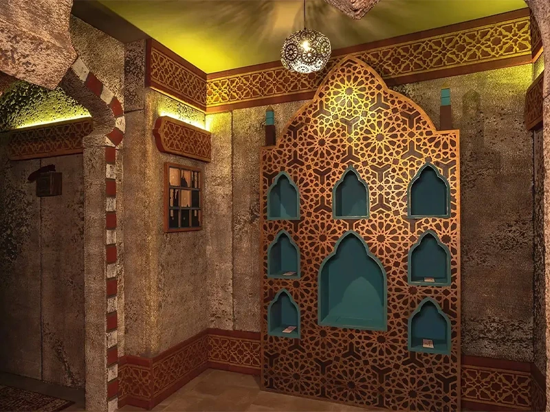 Elegantes Interieur mit kunstvoller Wandverzierung und arabischen Elementen in warmen Farbtönen. Ideal für stilvolle Räume.