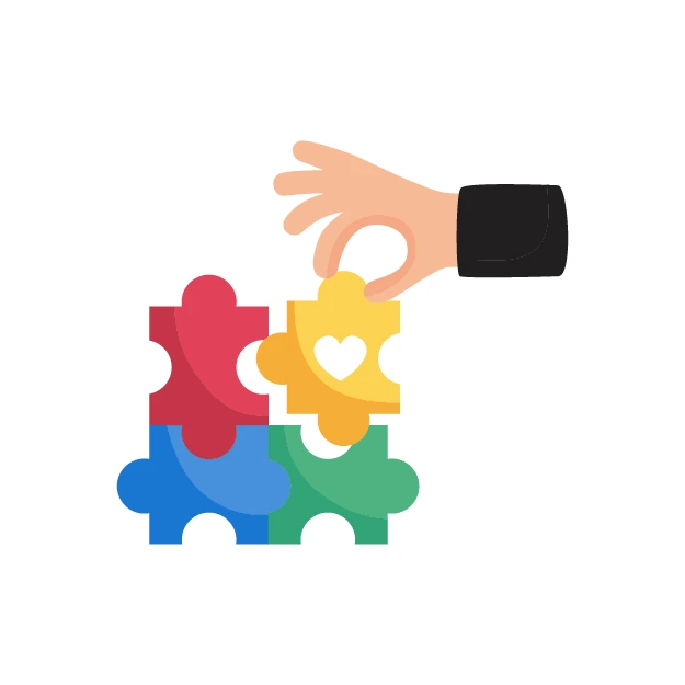 Eine Hand fügt ein gelbes Puzzlestück mit Herzsymbol in ein buntes Puzzle ein, das Zusammengehörigkeit symbolisiert.